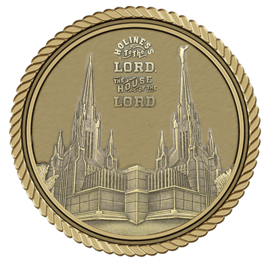 A gold medal with the image of an old church.